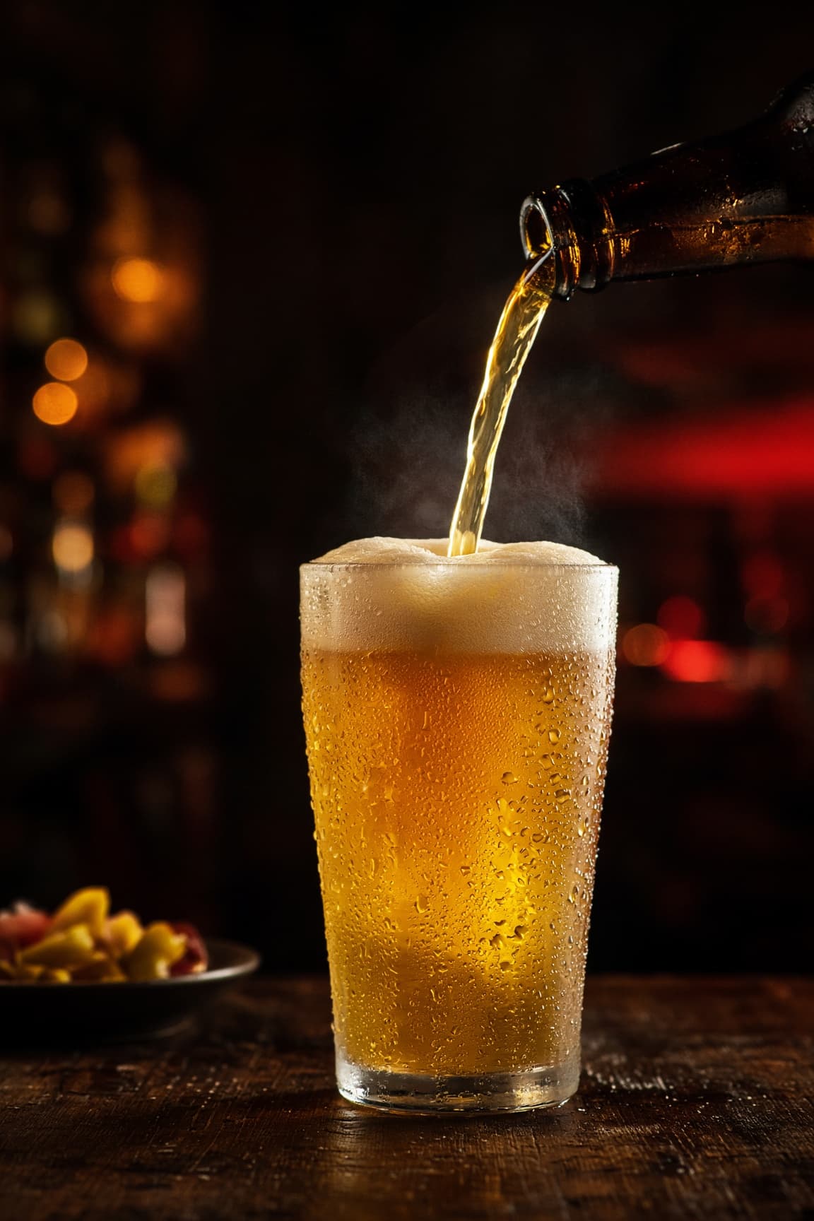 A frosty pint of beer being poured